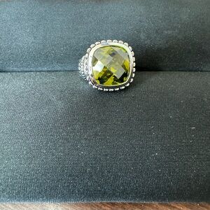 Silver toned ring with green man made stone